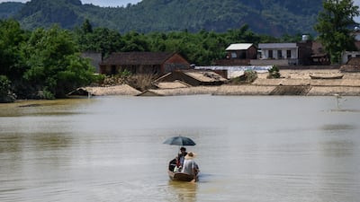 Residents on a boat in a flooded area after heavy rains in Yingde, Qingyuan city, in China's southern Guangdong province. AFP