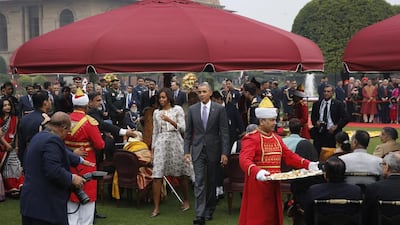 US president Barack Obama, walking with first lady Michelle Obama, during a reception hosted by Indian president Pranab Mukherjee on India’s Republic Day at the presidential palace on January 26, 2015. Manish Swarup/AP Photo