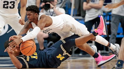 Penn State's Jamari Wheeler jumps on Michigan's Muhammad-Ali Abdur-Rahkman looking for the steal during the second half of an NCAA college basketball game in State College. Chris Knight / AP Photo