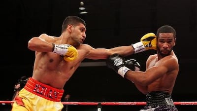 Amir Khan goes on the attack against Lamont Peterson during their WBA Super Lightweight and IBF Junior Welterweight title fight at Washington Convention. Al Bello