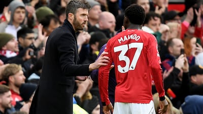 Manchester United interim manager Michael Carrick speaks with Kobbie Mainoo. Reuters