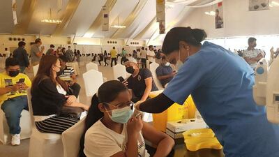 Akhilla Kannan, an eighth grader at Delhi Private School Dubai receives her first dose.