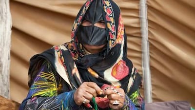 A trader works on her crafts at the camel races in Ras al Khaimah. For many it is their main source of income, and often they make only Dh100 a day.