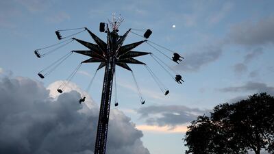 Fairgoers spin around on a carnival ride during the Miami-Dade County Fair & Exposition in Miami, Florida. EPA