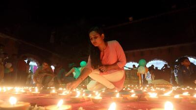 Indian people light oil lamps during the Deep Utsav or Light festival at the historical Gauhar Mahal palace, ahead of the Diwali festival in Bhopal. Sanjeev Gupta / EPA