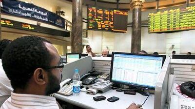 A broker monitors stock prices in Cairo, where the benchmark EGX 30 index rallied for the fourth consecutive day. Khaled Elfiqi / EPA