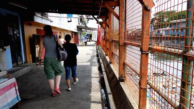 The slum runs along the Pasig River.