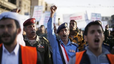 Army and police officers loyal to the Houthi movement shout slogans as they take part in a demonstration to show support to the movement in Sanaa last month. Khaled Abdullah / Reuters