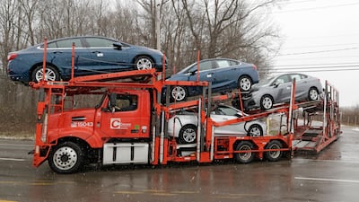 A transporter leaves GM's Lordstown plant. GM put five plants up for possible closure, potentially signalling a US recession ahead. AP