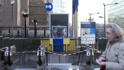 A woman walks past a closed subway station outside EU headquarters in Brussels on November 23 Virginia Mayo / AP