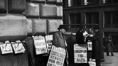 Newspaper placards in London announce the conscription of all men aged 20 and 21 into the army in 1939