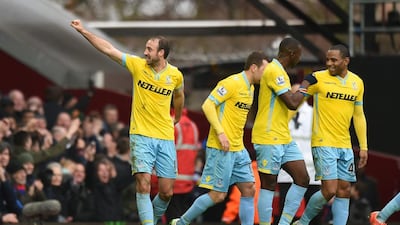 Glenn Murray, left, celebrates with teammates after he scoring his second and Crystal Palace's third goal in a 3-1 win over West Ham United. Tony O'Brien / Reuters