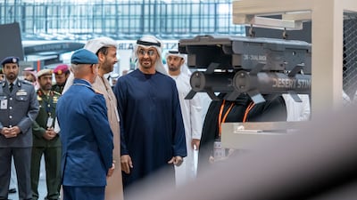 Sheikh Mohamed, Lt Gen Al Mazrouei and Mr Al Bannai review defence equipment during a tour of Idex