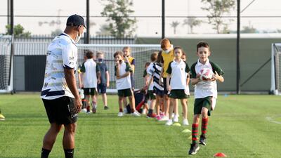 Osea Kolinisau and his Speranza 22 teammates lead a training session for young rugby players in Dubai.