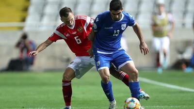 Russia's Denis Cheryshev, left, fights for the ball with Cyprus' Ioannis Kousoulos during the Euro 2020 qualifier at GSP Stadium in Nicosia. AP