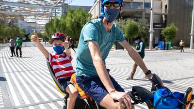 James from England is all thumbs up on his bike at the Expo site on a Sunday morning. Victor Besa / The National