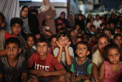 Palestinian children gather for an outdoor cartoon screening in Gaza city. AFP