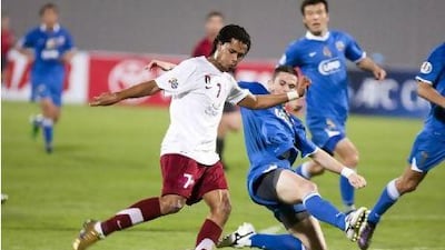 Mohamed al Shehhi, left, takes a shot at goal against Bunyodkor at Al Nahyan Stadium last night.