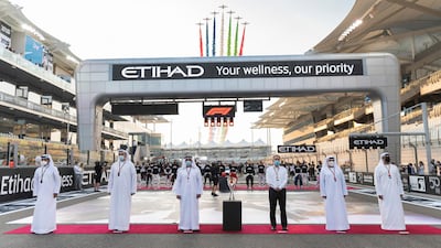 Sheikh Saif bin Zayed, Deputy Prime Minister and Minister of Interior (3rd L) stands for the national anthem prior to the final race of the 2020 Formula 1 season at Yas Marina Circuit. Mohamed bin Sulayem, FIA Vice President and President of the Automobile and Touring Club for the UAE (L) Khaldoon Al Mubarak, CEO and Managing Director Mubadala, Chairman of the Abu Dhabi Executive Affairs Authority and Abu Dhabi Executive Council Member (2nd L) and Chase Carey, Formula 1 Chairman and CEO (4th L) are also pictured. Hamad Al Kaabi / Ministry of Presidential Affairs 