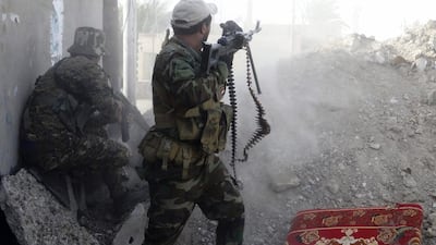 Iraqi Shiite Hezbollah Brigade militiamen fire weapons against ISIL militants in Husaybah, east of Ramadi. AP Photo