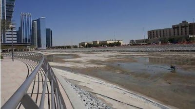 Lake C in Jumeirah Lakes Towers has been emptied out to begin construction of a 55,000-square metre park, a move welcomed by some residents. Razan Alzayani / The National