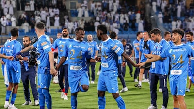 Al Hilal's players celebrate their SPL title victory on the pitch after the win against Al Hazm. AFP