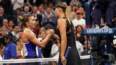 Maria Sharapova and Simona Halep shake hands at the net after the Russian's victory. Don Emmert / AFP
