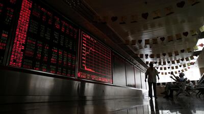 People react as they monitor stock prices at a brokerage house in Beijing, Thursday, Aug. 16, 2018. Asian shares are falling as investors fret over slowing economic growth, especially in China. Technology stocks and oil and metals prices skidded overnight on Wall Street. (AP Photo/Andy Wong)