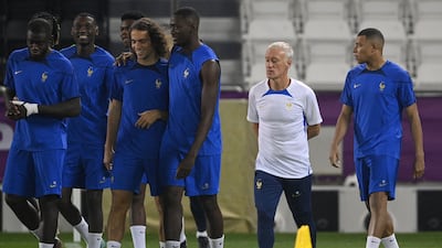 France's coach Didier Deschamps oversees a training session of his players including France's forward Kylian Mbappe (R) at the Al Janoub stadium in Al-Wakrah / Al Sadd SC Training site in Doha, on November 21, 2022, on the eve of the Qatar 2022 World Cup football match between France and Australia. (Photo by FRANCK FIFE / AFP)
