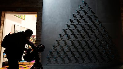Makov's installation comprises 78 light blue funnels mounted on a triangle through which water flows, slowing as it travels downwards to drip slowly into the collecting basin, echoing in the otherwise silent space. AP
