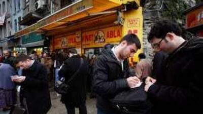 People play Super Lottery in front of Nimet Abla's shop in the Eminunu district of Istanbul this week.