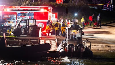 Rescuers gather on the shore of the Patapsco River for an operation authorities described as a 'mass casualty, multi-agency rescue'. EPA