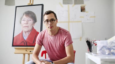 Dubai-based artist Edward Sutcliffe is photographed with his painting of Glenda Jackson in his home studio. Sarah Dea / The National