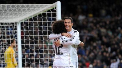 Cristiano Ronaldo of Real Madrid celebrates with teammate Marcelo after recording his La Liga record 23rd hat-trick on Saturday against Celta Vigo. Denis Doyle / Getty Images