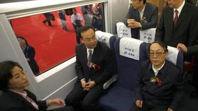 Liu Zhijun, centre, the former Chinese minister of railways, at the rolling off ceremony of a 380A bullet train named He Xie, meaning harmony in Chinese.