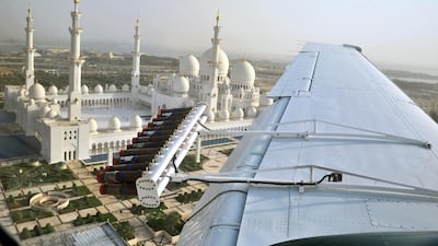 A National Centre for Meteorology and Seismology cloud-seeding plane flies over the Sheikh Zayed Mosque in Abu Dhabi. Courtesy National Centre for Meteorology and Seismology