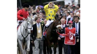 Christophe Lemaire, the French jockey, centre, tries to take in his victory on Dunaden in the Melbourne Cup yesterday, after holding off Red Cadeaux's challenge.