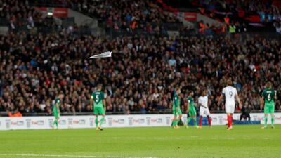 Paper aeroplanes are thrown onto the pitch by fans. Carl Recine / Reuters