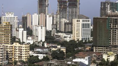 Towers stand under construction among other residential and commercial buildings in the Mahalaxmi area of Mumbai. Dhiraj Singh / Bloomberg