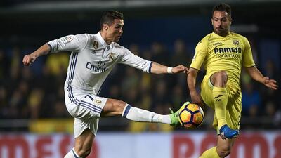 Villarreal’s Mario Gaspar, right, competes for the ball with Cristiano Ronaldo of Real Madrid. Getty Images