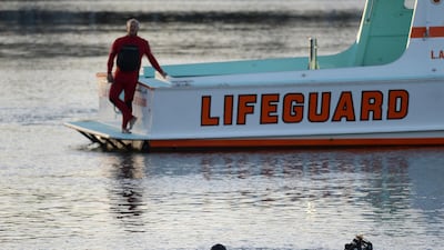 Divers search the area where a car went off a pier and into the water in Los Angeles on April 9, 2015. AP