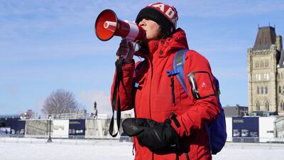 Benita Pedersen uses a loud speaker to talk to a crowd gathered outside of the Canadian Parliament. Willy Lowry / The National