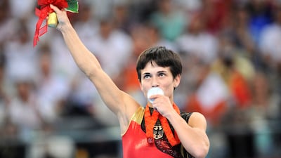 Germany's Oksana Aleksandrovna Chusovitina stands on the podium during the medal ceremony of the women's vault final of the artistic gymnastics event of the Beijing 2008 Olympic Games in Beijing on August 17, 2008. North Korea's Un Jong Hong won the gold, Germany's Oksana Aleksandrovna Chusovitina the silver and China's Fei Cheng the bronze.