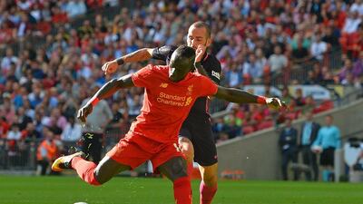 Liverpool forward Sadio Mane shoots to score the opening goal. Glyn Kirk / AFP
