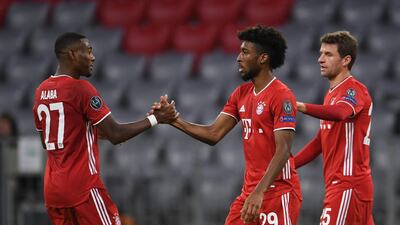Bayern Munich's Austrian defender David Alaba, left, congratulates French forward Kingsley Coman on scoring the opening goal during the UEFA Champions League Group A match against Atletico Madrid in Munich. AFP