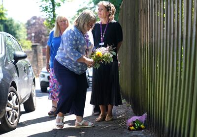 Staff from a local hospice lay flowers in Nottingham. PA