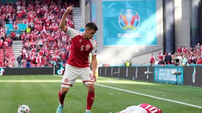 Denmark's Joakim Maehle reacts as Denmark's Christian Eriksen collapses during the Euro 2020 soccer championship group B match against Finland at Parken stadium in Copenhagen on June 12. Eriksen was discharged from hospital nearly a week after the incident. AP