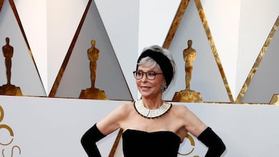TWO WOMEN WHO WORE 'AN OLD' DRESS: Rita Moreno, the 86 year old veteran of films like The King and I, wore exactly the same gown she wore in 1962 to accept the Best Supporting Actress award for her role in West Side Story. Moreno decided to give it another spin, this time recutting it to be strapless, but with the same magnificent jacquard woven skirt, with great golden roundals. Mixing it with long opera gloves, and simple headband and a heavy collar necklace, she looked, quite simply, fabulous. As the rest of us struggle to get into last year's jeans, that she could slip into a dress she last wore fifty six years ago is in itself worthy of an award.