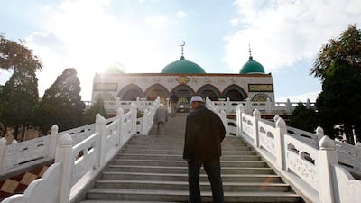 A Chinese Muslim man ascends the staircase to the mosque. Sarah Dea / The National