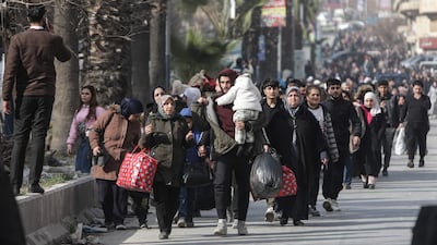 Residents leave Aleppo's Kurdish-majority Ashrafieh neighbourhood after the Syrian army warned it would strike 'military targets' in the city. AFP